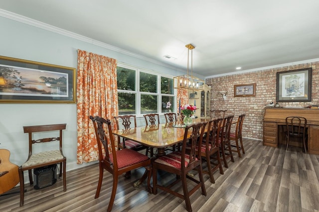 dining space with an inviting chandelier, crown molding, dark hardwood / wood-style floors, and brick wall