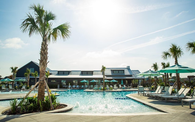 view of pool featuring pool water feature and a patio area