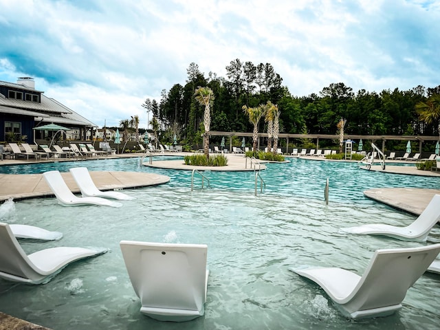 view of swimming pool with a patio and pool water feature