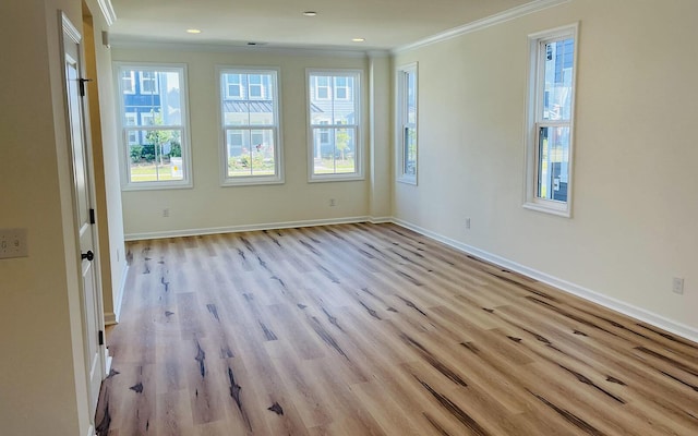 unfurnished room with crown molding and light wood-type flooring