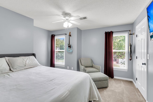 100 Conset Bay Ct, Goose Creek, SC 29445 - bedroom featuring light colored carpet, baseboards, multiple windows, a ceiling fan, and a textured ceiling