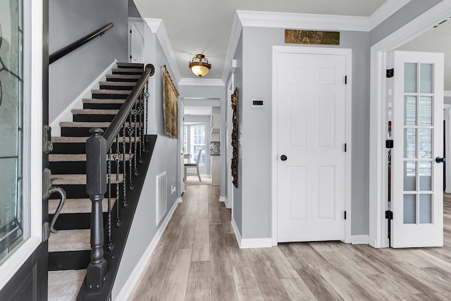 100 Conset Bay Ct, Goose Creek, SC 29445 - entrance foyer featuring light wood-style flooring, crown molding, baseboards, and stairs
