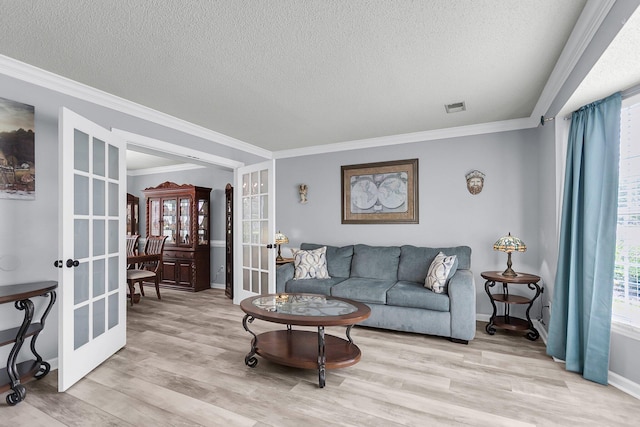 100 Conset Bay Ct, Goose Creek, SC 29445 - living room featuring french doors, a textured ceiling, crown molding, light wood-style flooring, and baseboards