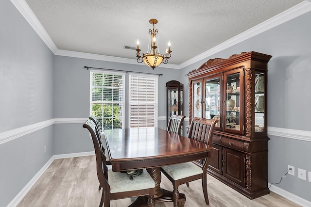 100 Conset Bay Ct, Goose Creek, SC 29445 - dining space with a chandelier, light wood finished floors, a textured ceiling, baseboards, and ornamental molding