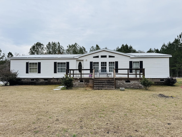 manufactured / mobile home featuring a front yard and a deck