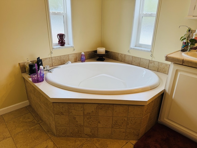 bathroom featuring vanity and tiled tub