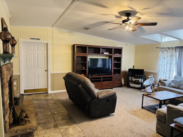 living room featuring lofted ceiling, tile patterned floors, ornamental molding, and ceiling fan