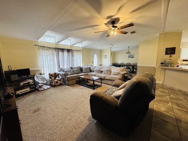 living room featuring ceiling fan, lofted ceiling, carpet flooring, and a textured ceiling