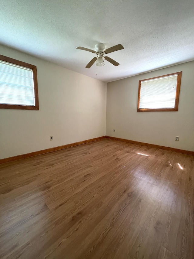 6287 Sniders Hwy, Walterboro, SC 29488 - unfurnished room featuring wood finished floors, baseboards, a textured ceiling, and a ceiling fan