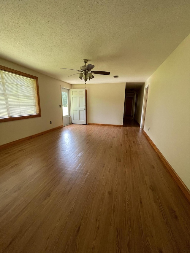 6287 Sniders Hwy, Walterboro, SC 29488 - unfurnished room featuring a textured ceiling, wood finished floors, a ceiling fan, and baseboards