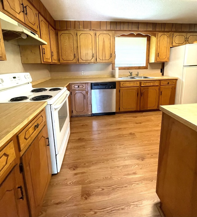 6287 Sniders Hwy, Walterboro, SC 29488 - kitchen with white appliances, under cabinet range hood, a sink, light countertops, and light wood-style floors
