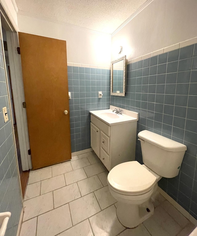 6287 Sniders Hwy, Walterboro, SC 29488 - half bath featuring tile walls, a textured ceiling, vanity, toilet, and crown molding
