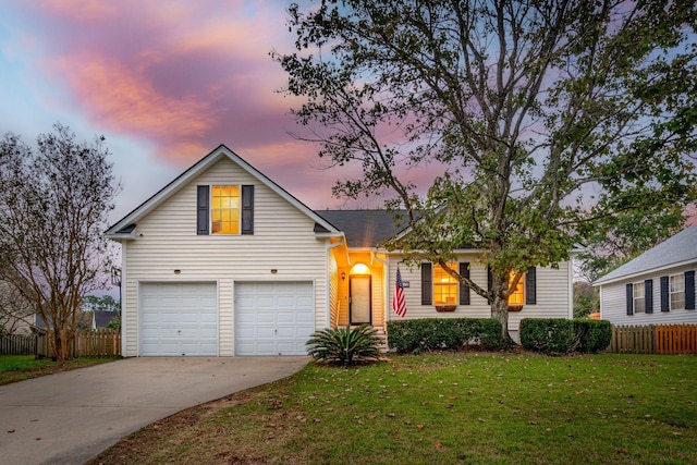 view of front of home featuring a yard and a garage