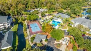 bird's eye view of a pool area and a nearby body of water