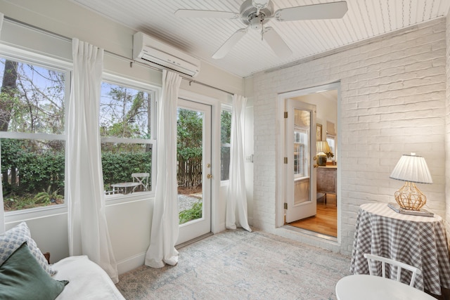 sunroom with a wall mounted air conditioner, plenty of natural light, and ceiling fan