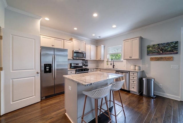2024 Lanneau Ln, Johns Island, SC 29455 - kitchen featuring appliances with stainless steel finishes, ornamental molding, tasteful backsplash, dark wood-style floors, and a breakfast bar area