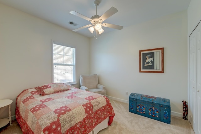 bedroom with carpet flooring, a ceiling fan, visible vents, baseboards, and a closet