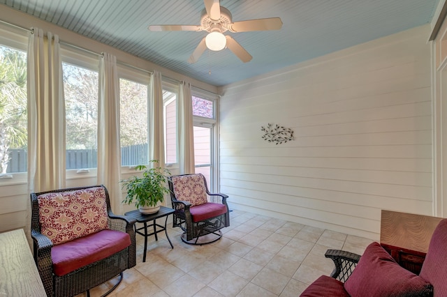 sunroom / solarium featuring ceiling fan