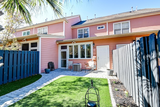 back of house with a yard, a patio area, fence, and central AC unit