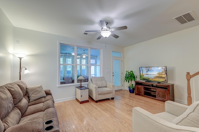 living area with a ceiling fan, light wood-style flooring, visible vents, and baseboards