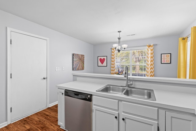 kitchen with visible vents, dark wood finished floors, dishwasher, light countertops, and a sink