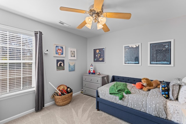 carpeted bedroom with ceiling fan, visible vents, and baseboards