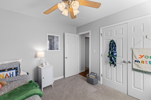 bedroom with ceiling fan, carpet floors, a closet, and baseboards