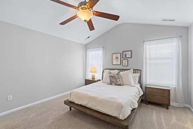 bedroom with light carpet, baseboards, visible vents, and lofted ceiling