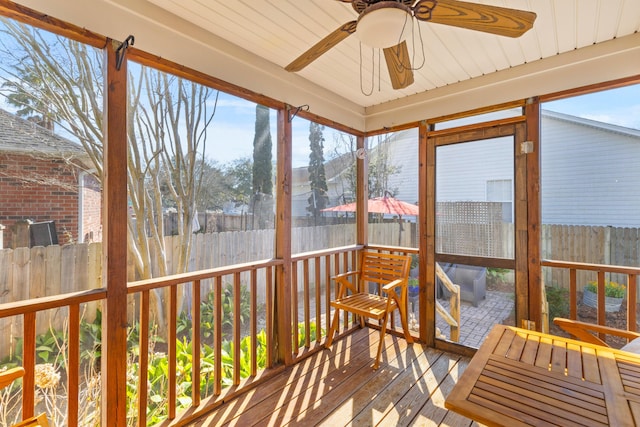 sunroom / solarium featuring ceiling fan and a wealth of natural light