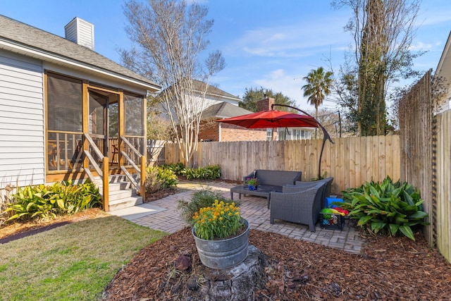 view of yard with a sunroom, a fenced backyard, a patio, and outdoor lounge area