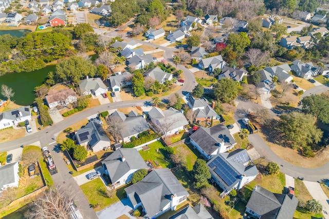 birds eye view of property with a residential view and a water view