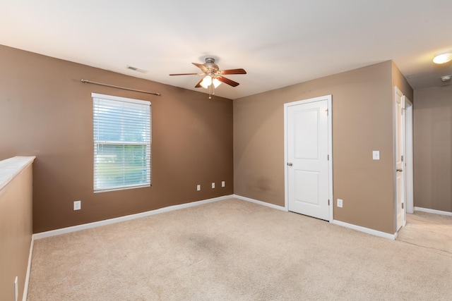 interior space featuring ceiling fan and light carpet