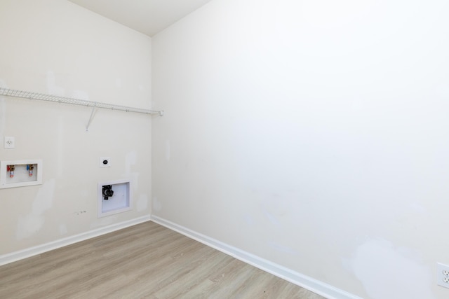 clothes washing area with electric dryer hookup, washer hookup, and light wood-type flooring