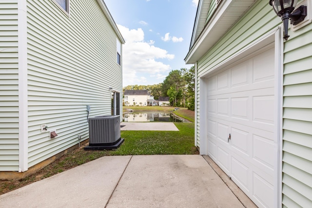 garage featuring central AC and a lawn