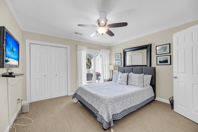 bedroom featuring crown molding, a closet, light colored carpet, visible vents, and ceiling fan