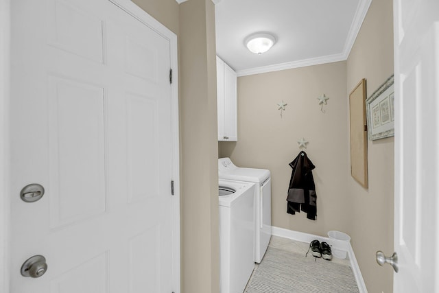 clothes washing area featuring light tile patterned flooring, separate washer and dryer, baseboards, ornamental molding, and cabinet space