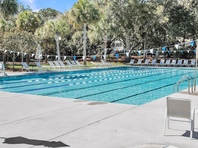 community pool featuring a patio area and fence