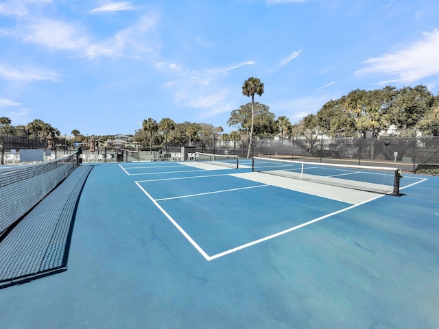 view of sport court featuring fence