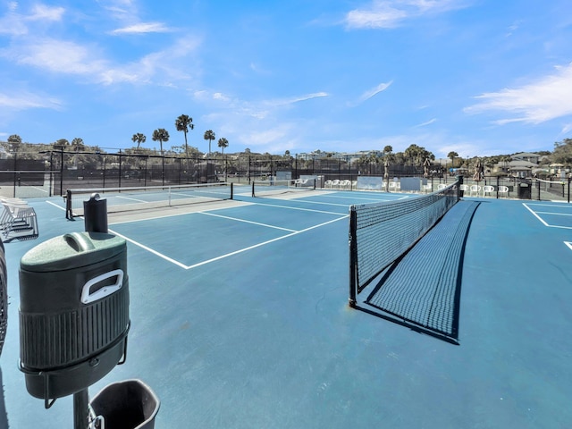 view of tennis court with fence