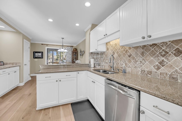 kitchen with tasteful backsplash, stainless steel dishwasher, a sink, and crown molding