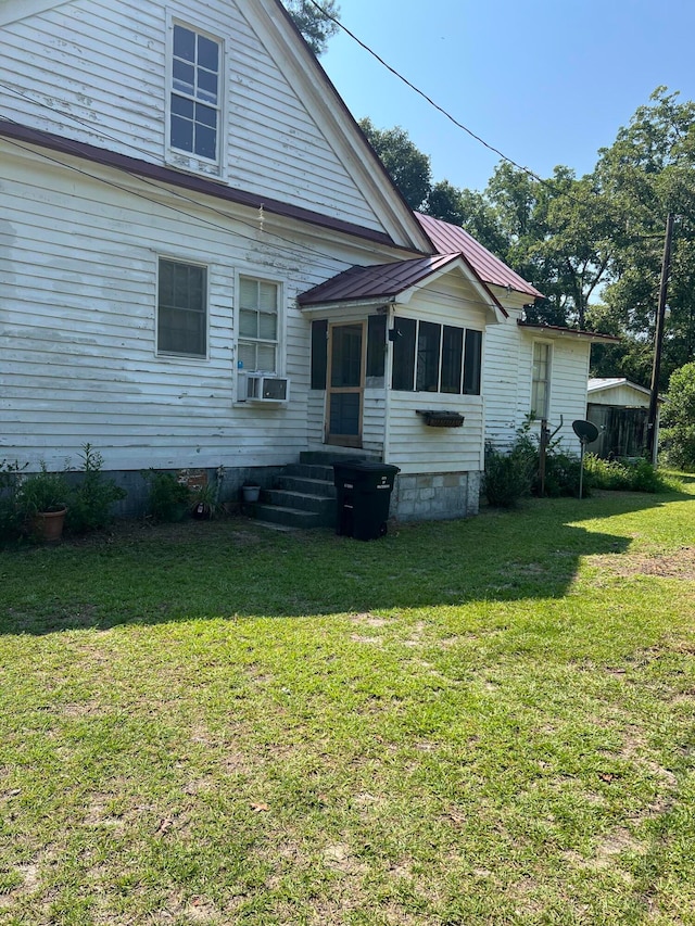 back of house with a lawn and cooling unit