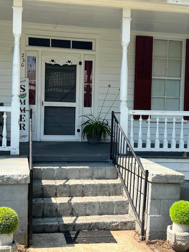 view of exterior entry featuring a porch