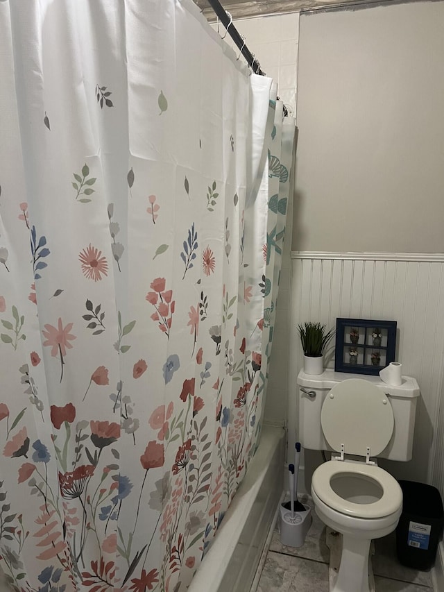 bathroom with toilet and shower / bath combination with curtain