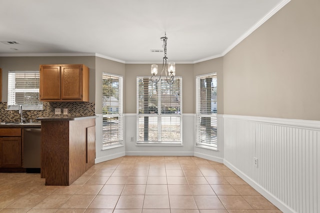 interior space featuring light tile patterned floors, a sink, visible vents, stainless steel dishwasher, and dark countertops