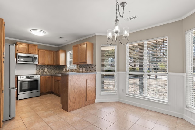 kitchen with stainless steel appliances, pendant lighting, visible vents, and crown molding