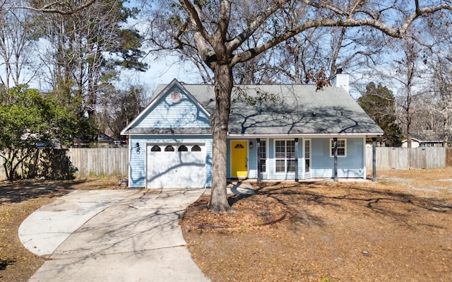 view of front facade with covered porch, a garage, fence, concrete driveway, and a chimney