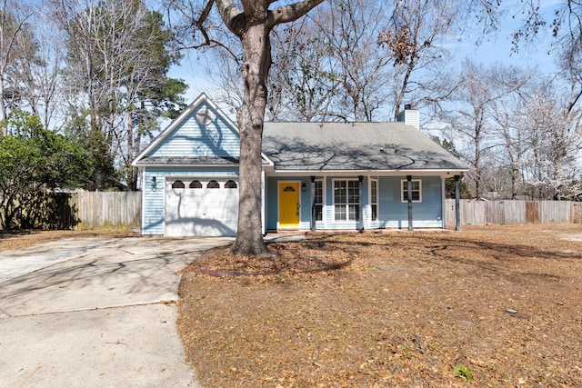 single story home with driveway, a garage, a chimney, covered porch, and fence