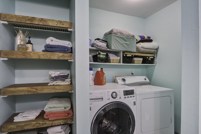 clothes washing area featuring washing machine and dryer