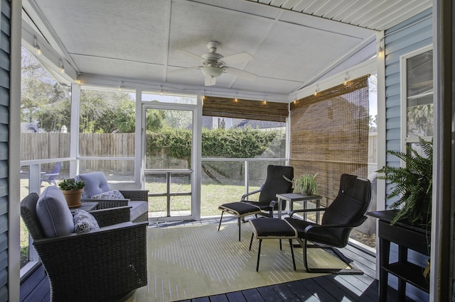 sunroom featuring ceiling fan and vaulted ceiling