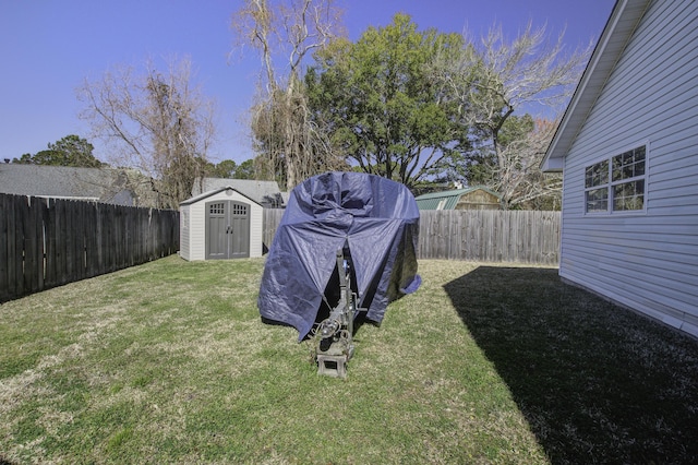 view of yard with a fenced backyard, a storage shed, and an outdoor structure